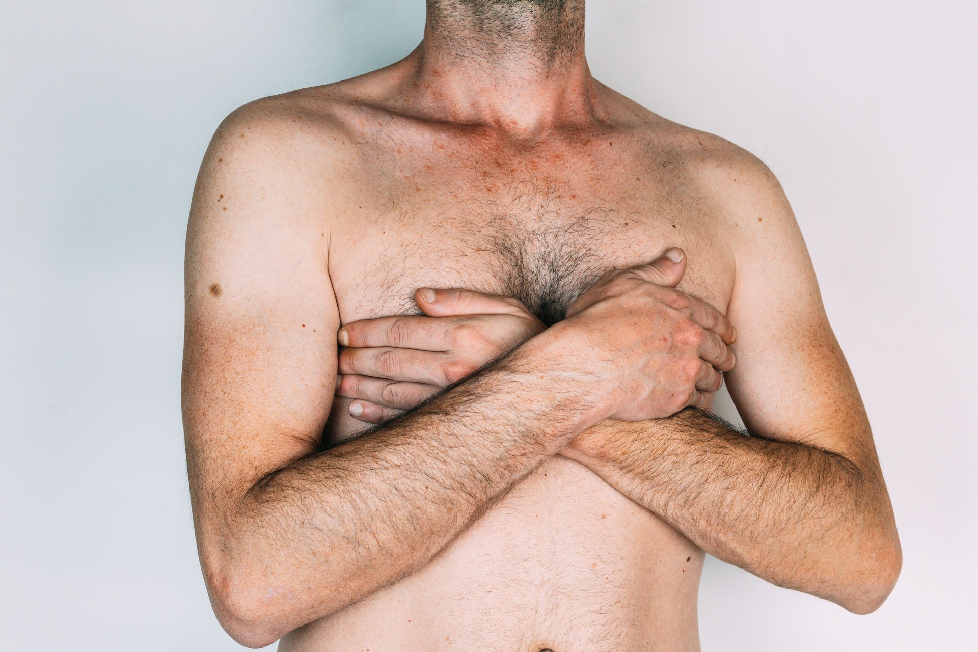 man with hands on chest